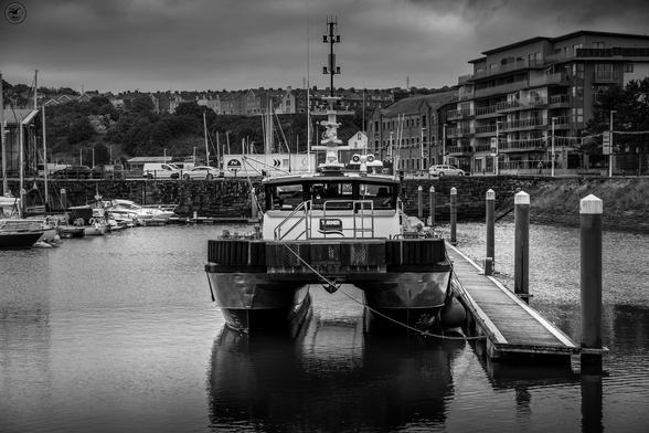 Monochrome shot of whitehaven harbour with mix of commercial and pleasure boats at dock