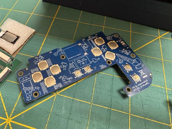 The opposite side of one of the previously shown circuit boards showing that it is covered in small line at cartoon drawings.
