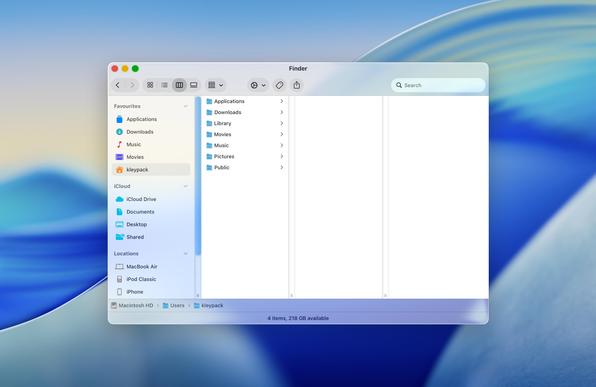 A mockup of a Finder window on a macOS desktop. There is a glassy title bar with window controls at the top with a toolbar below. At the bottom are a glassy status bar and path bar. The bulk of the window, in between, consists of a frostier glass sidebar on the left and a white main content area, in column view, on the right.