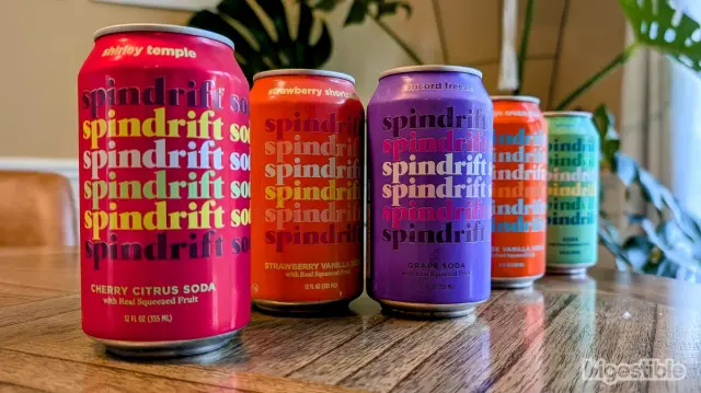 Five cans of Spindrift Soda lined up on a table.