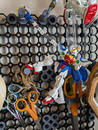 The HG Shenlong Gundam on a 3D printed pegboard with various embroidery tools