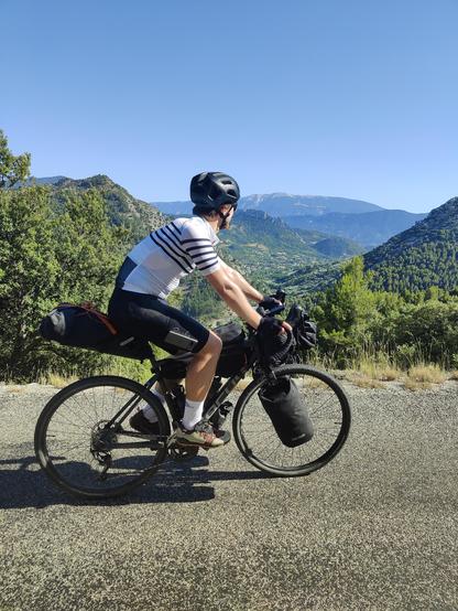 Cyclist looking at Mont Ventoux from a hill around 15 km away.