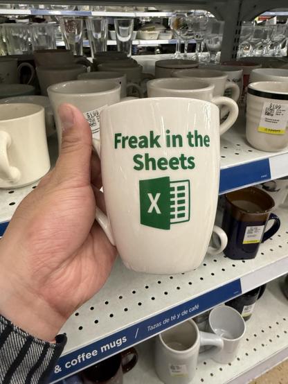 a mug that says "freak in the sheets" with the excel logo