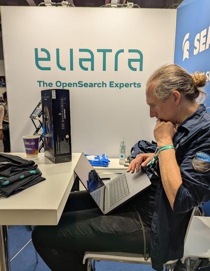 Developer working on code at a conference booth