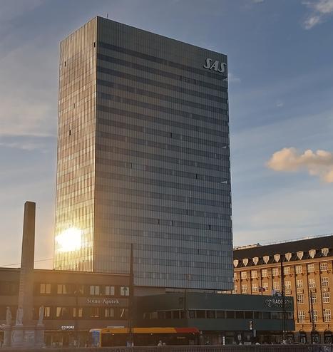 SAS Royal Hotel, Kopenhagen, Denmark, with the reflection of the setting sun on its aluminium facade