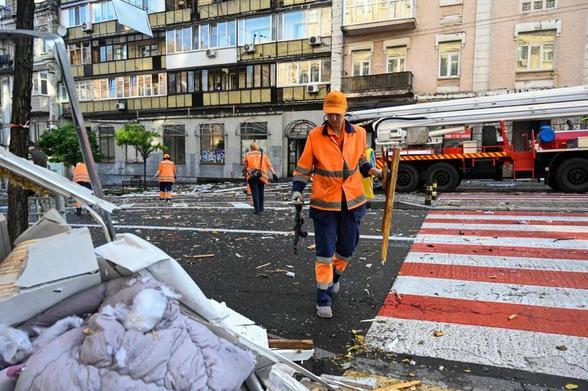A communal worker is seen working at the site of a Russian attack that damaged a residential building in Kyiv, Ukraine in July 2025
