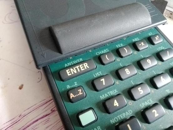 The enter key of a calculator much as it appeared in the shop under a pile of others