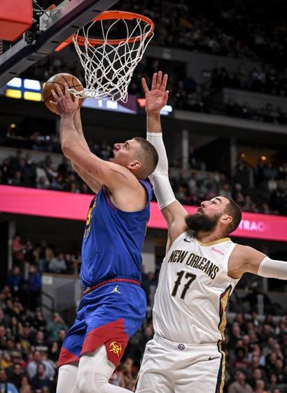 Nuggets head coach David Adelman sees Jonas Valanciunas as point center