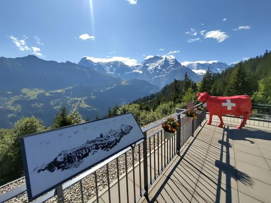 View from look-out terrace at Grütschalp with Eiger, Mönch & Jungfrau. A big fake red cow with the Swiss cross makes it very touristy.
