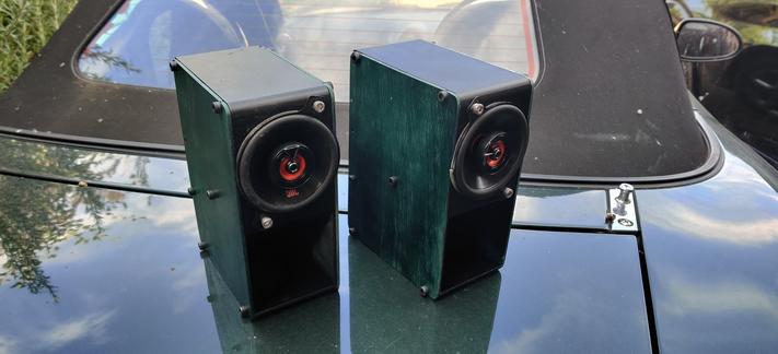 Two speakers say on the boot of an mx5 showing the colour matched panels