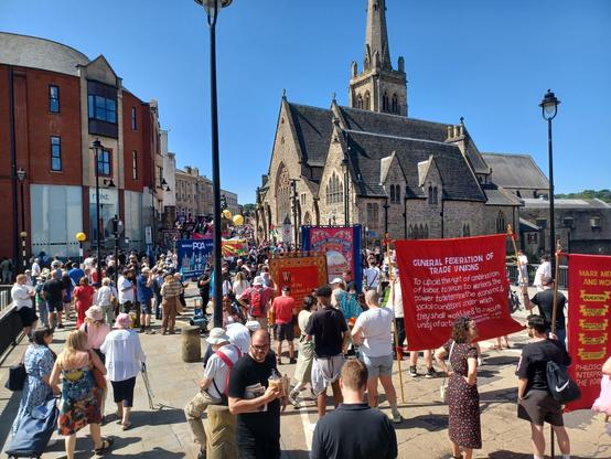 View from the back of the march forward, on the bridge before the church. i don't know which street we were on in durham. you can see ppl carrying banners.