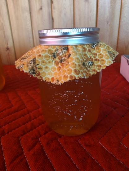 My mom cuts out various bee-themed doilies to decorate the lids. We also add labels & warnings not to feed to children under 1 year.