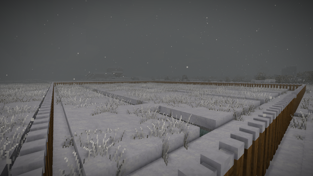 Screenshot from the game Vintage Story, on the screenshot you can see a fence around an area covered in snow. This area is a further farmland but everything is frozen.

Also there is some snowfall going on and the view distance is really limited as it appears to be foggy.