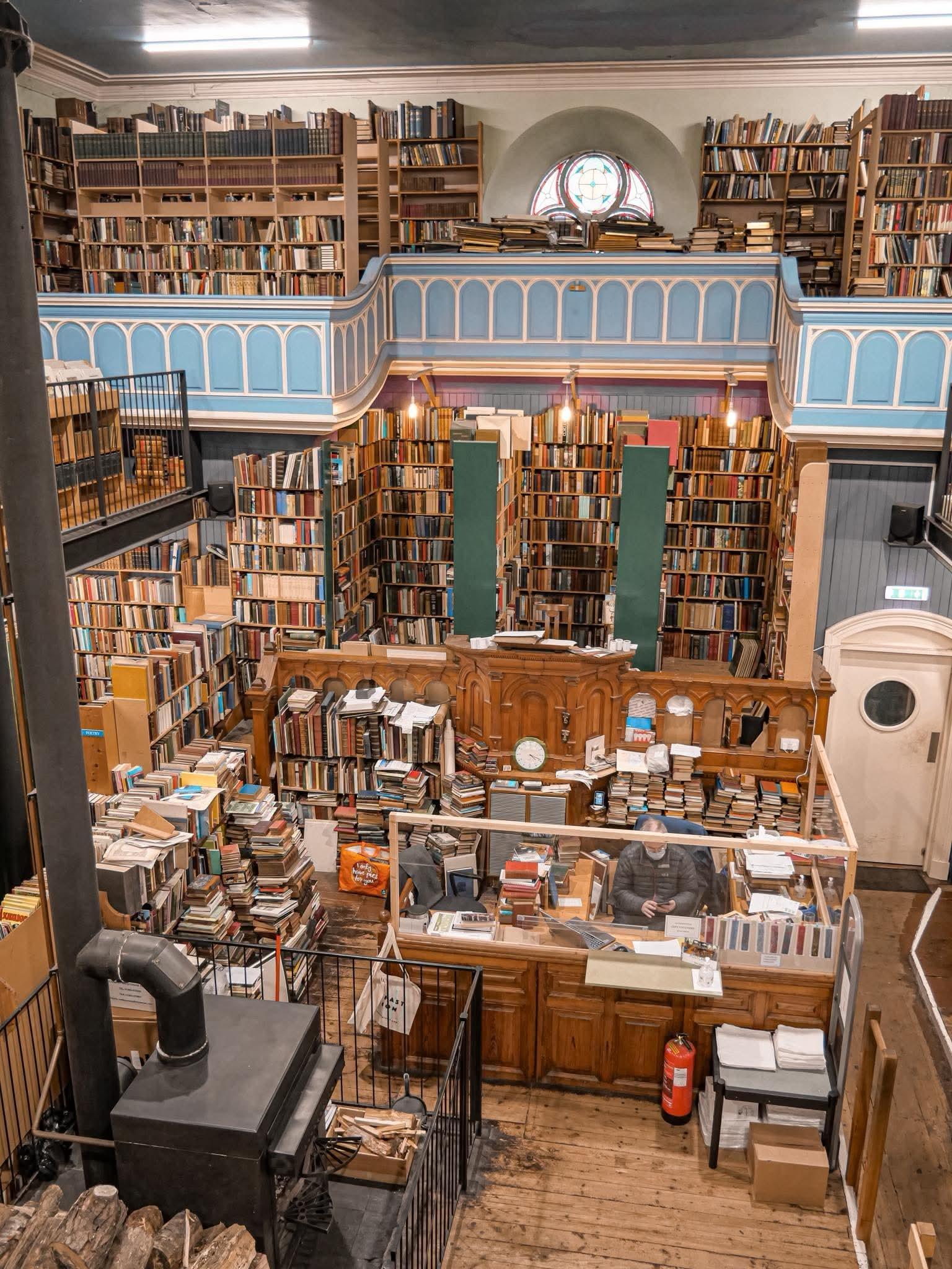 The interior of a church, now converted as a book shop. Everywhere there are stacks of books, books on shelves, tier upon tier of books!