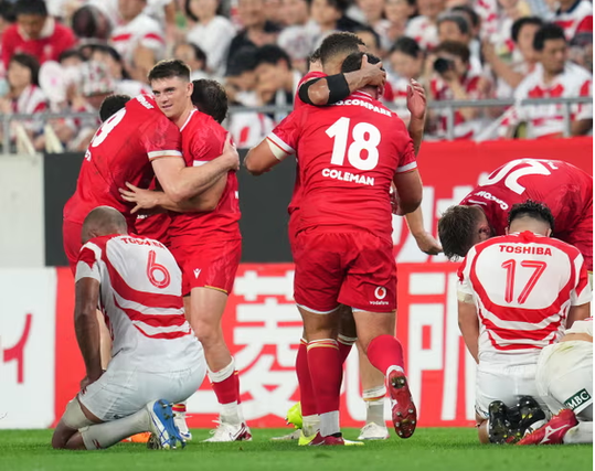 Wales players celebrate victory in in Kobe. Photograph: Masterpress/Getty Images