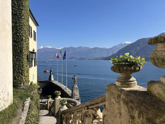 View of Lake Como, with flags at the hotel side, photographed by Elyse Glickman.