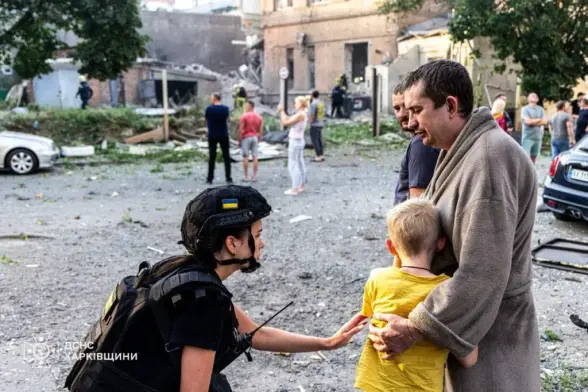 A State Emergency Service worker assists a family affected by Russian attacsk in Kharkiv, Ukraine, on July 11, 2025. (Ukraine's Emergency Service)
