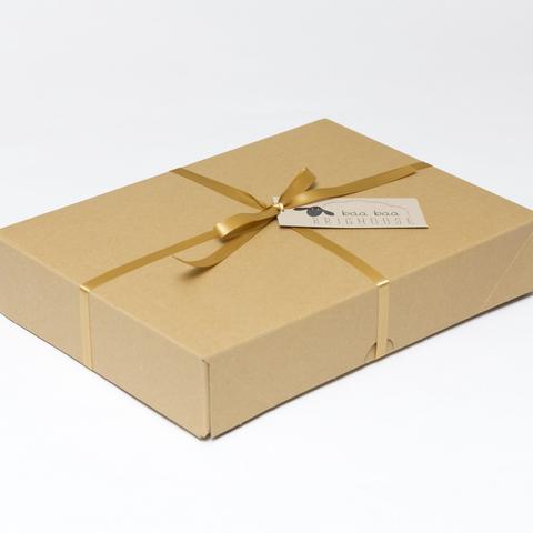 Picture shows a closed A4 box tied with gold ribbon.