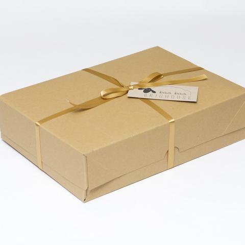 Picture shows a closed A4 box tied with gold ribbon.