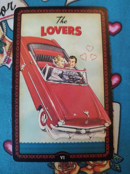 Card from the Housewives Tarot deck.
The Lovers-VI.
A young couple, a man and a woman, in love riding a convertible, which may be falling into a body of water. They are both happily looking at each other.