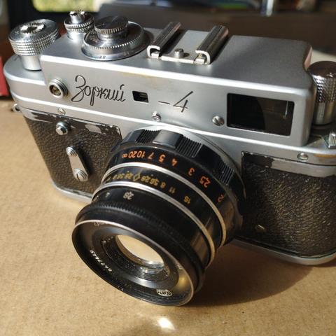 appareil photo en métal, pris 1/3 face droite légèrement en hauteur. des traces de patine sur les bords de son boîtier.