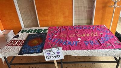 Banners and signs about queer liberation