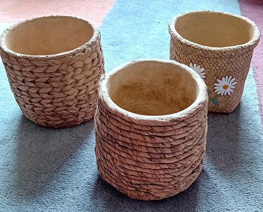 3 plant pot holders that look like rattan baskets.