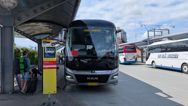 A bus next to an information sign about replacement services.
