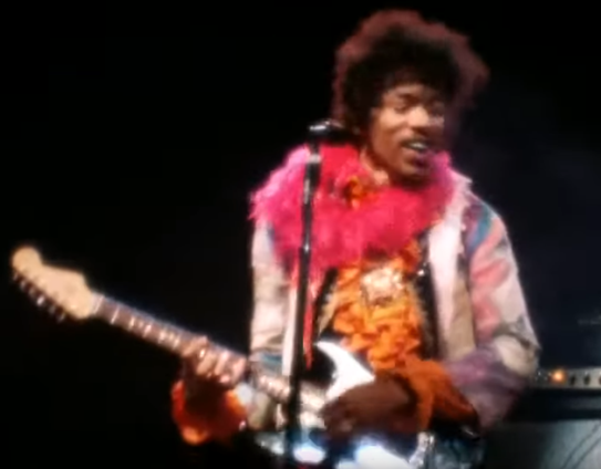 Jimi Hendrix playing guitar on stage at the 1967 Monterey Pop Festival
