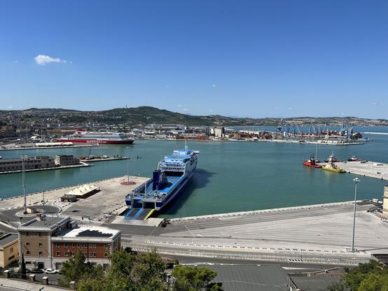 The harbour of Ancona from an elevated viewpoint. Two large cruise ships - one red-white and the other blue-white - are waiting for departure later that day.
