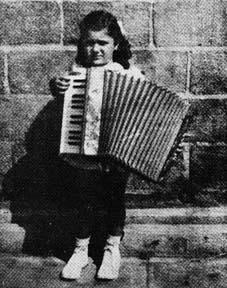 Connie with accordian as a child