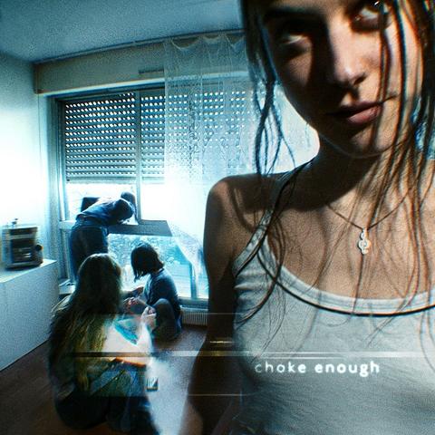 Cover of album choke enough by oklou. A woman is standing inside a room and other people at the background looking out of the window. Everything is bluish Y2K style.