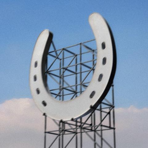 A horseshoe on top of a skeleton structure. Blue sky in the background.