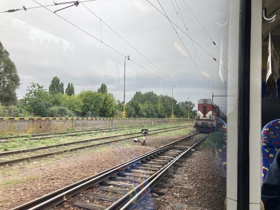 Freight locomotive seen through a passenger train window.
