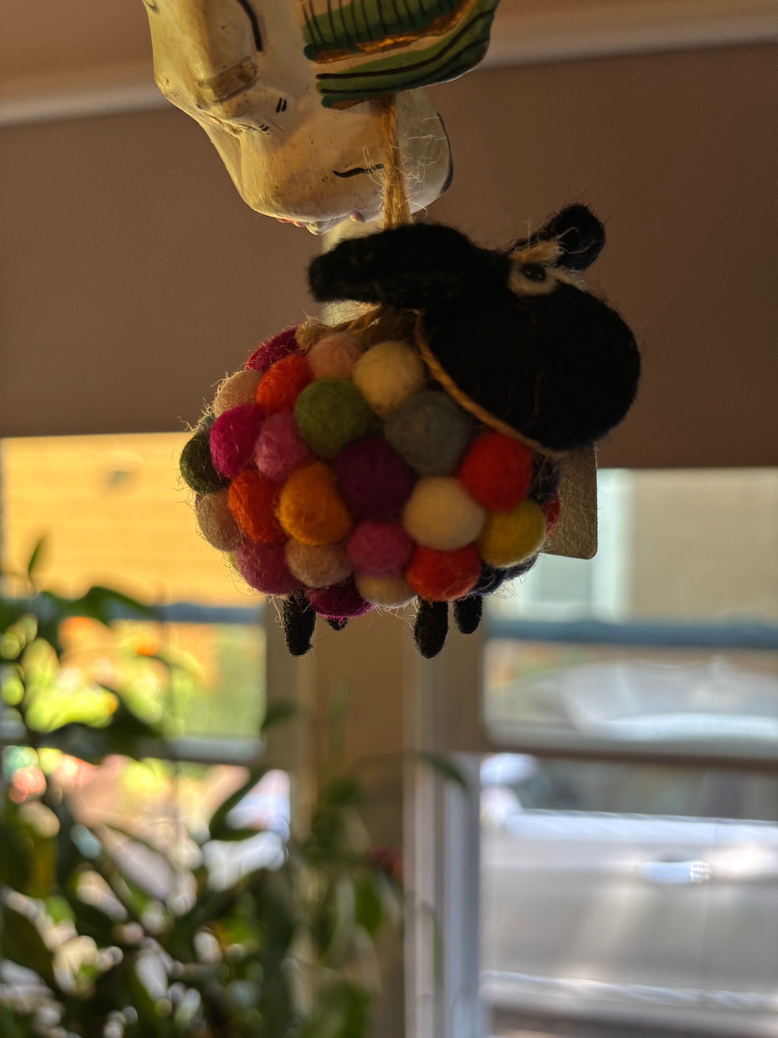 a silly figurine hanging in our house, like a sheep made from brightly colored cotton balls
