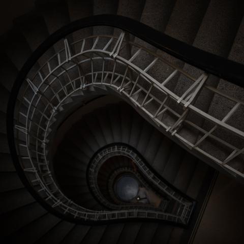 Photo of a staircase view from the top, inside a house in Prague