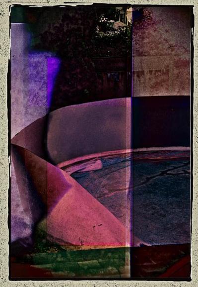 The composition includes an old style photo edge. It is a digitally created multiple exposure shot, with a mixture of very dark greens, pale purple & browns, and bright magentas.  Bits of the fencing, shrubs and a distant rooftop are visible. In the foreground at the bottom of the image, rough green roofing is visible. The central subject appears to be some sort of construction that includes a curving wall that bends inward. A flat area appears to be a pale blue-purple lined & cracked surface.