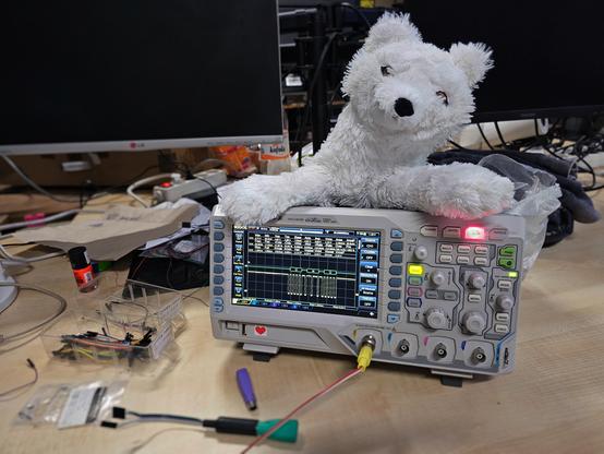 A plush fox on an oscilloscope. There is “UwU” on the scope.