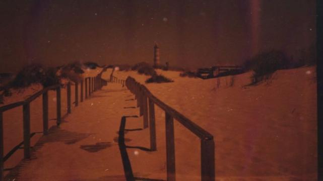 A redscaled view of the beach at Barra, Portugal.
