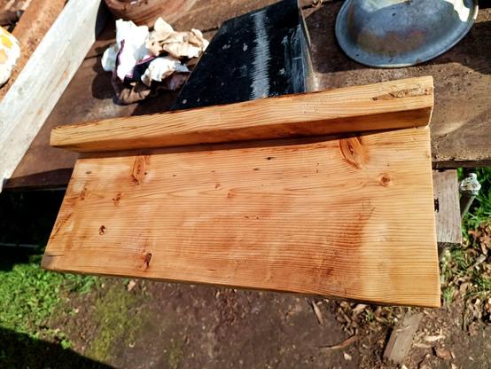 The same wood and a few cotton rags next to it. The wax has been re-heated and the excess wiped off, giving it a darker glow that brings out the pattern of the wood nicely instead of the foggy look previously.