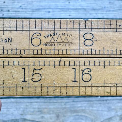 vintage folding brass and boxwood rule - showing two closed arms side by side, with the makers trademark and 6,8 on the top and upside down 15, 16 inch marks on the bottom