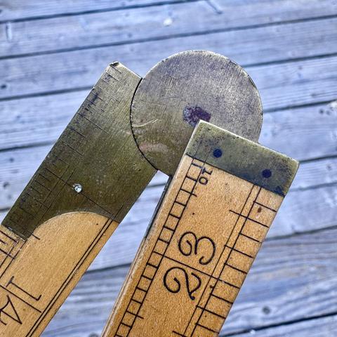 vintage folding brass and boxwood rule - showing the main circular hinge and the number 23