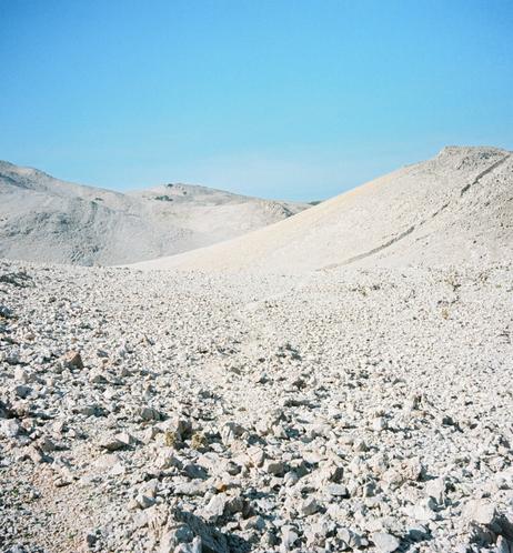 A lunar view, rocky hills with the extreme blue sky.