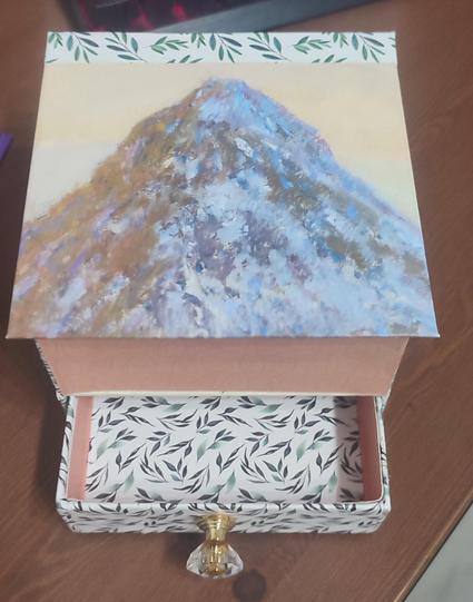 View from the top of a handmade hinged lid box with a drawer. Different decorations, with different patterns.