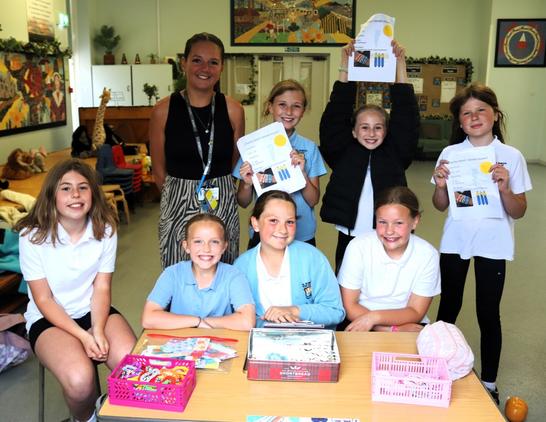 The pupils and Miss Elliw Roberts at their stall