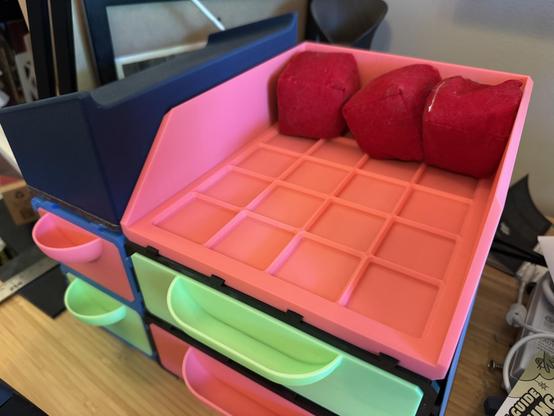 A close-up of the shelf on the 4 x 5 drawers with the tablet stands removed. You can see an Open grid Finity grid as well as three practice juggling sacks.