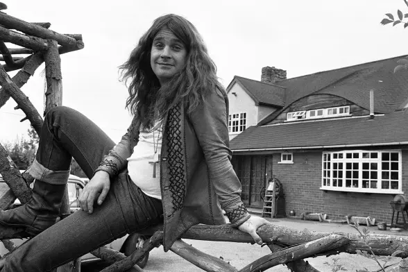 Young Ozzy Osbourne in front of his house
(black and white photo)