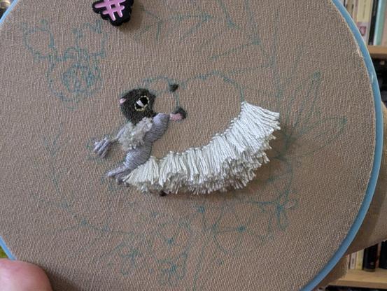 A bit further along, the entirety of the "shadowed" part of wooloo's wool is done in Turkey rug stitch in a slightly off-white pale grey.