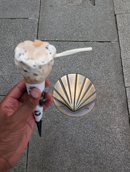 Me with a celebratory ice cream next to a Camino shell