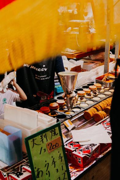 photo of a food vendor preparing something that looks like donuts